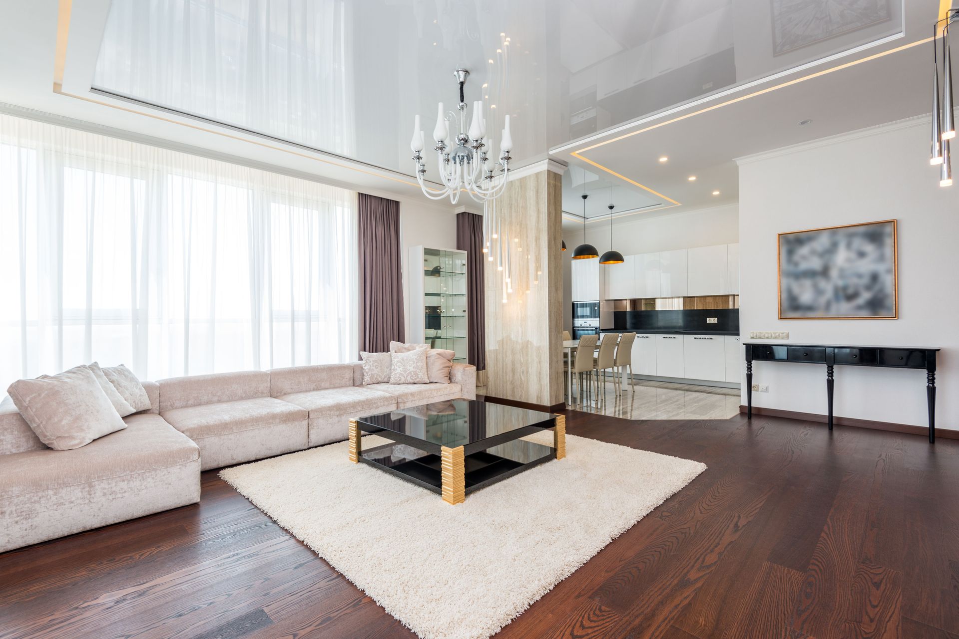 Spacious and elegant modern living room with chandelier and cozy elements.